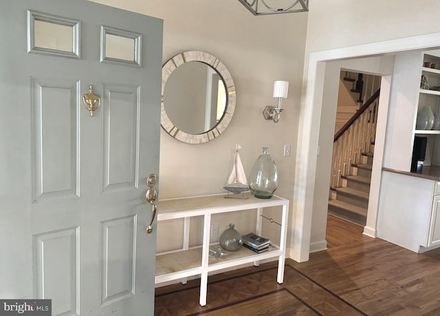 foyer featuring stairway and dark wood-style floors