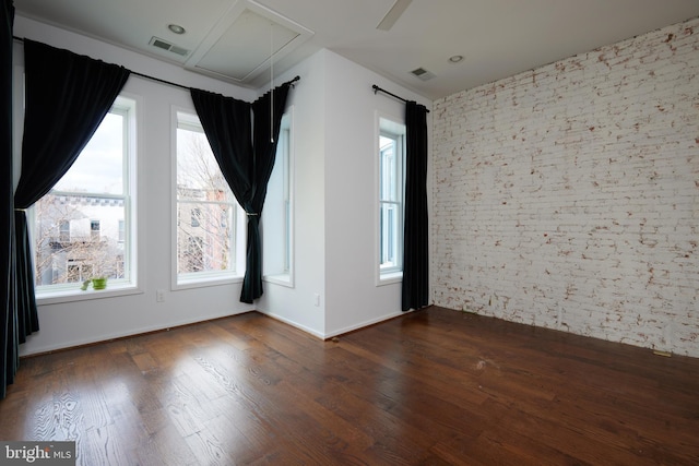 unfurnished room with plenty of natural light and dark hardwood / wood-style flooring