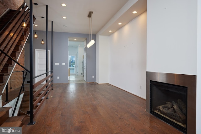 unfurnished living room with dark wood-type flooring