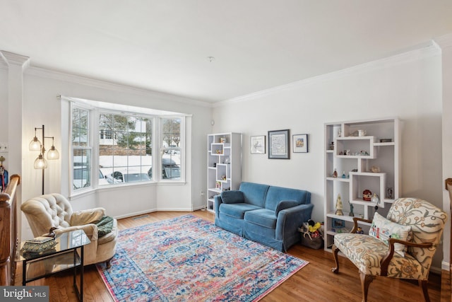 living room featuring hardwood / wood-style flooring and crown molding