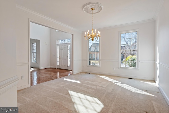 unfurnished dining area with carpet floors, baseboards, visible vents, and crown molding