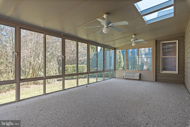 unfurnished sunroom with vaulted ceiling with skylight, ceiling fan, and an AC wall unit