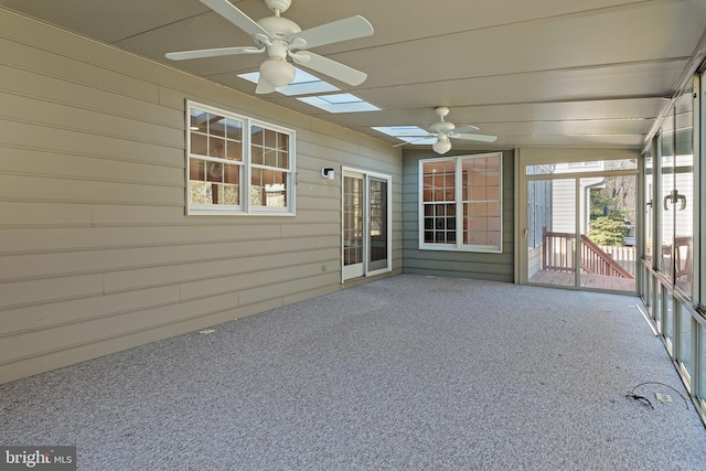 unfurnished sunroom featuring a ceiling fan