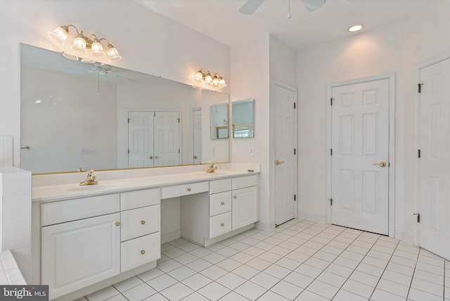 full bath with double vanity, ceiling fan, tile patterned floors, a sink, and a closet