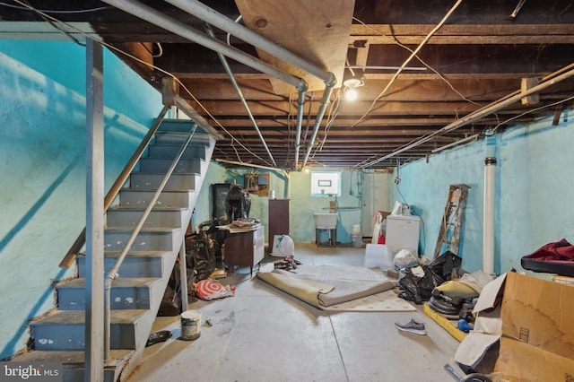 basement with sink and washer / dryer