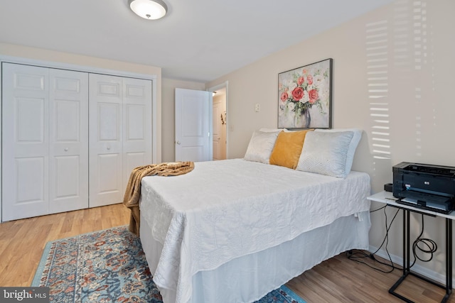 bedroom with hardwood / wood-style floors and a closet