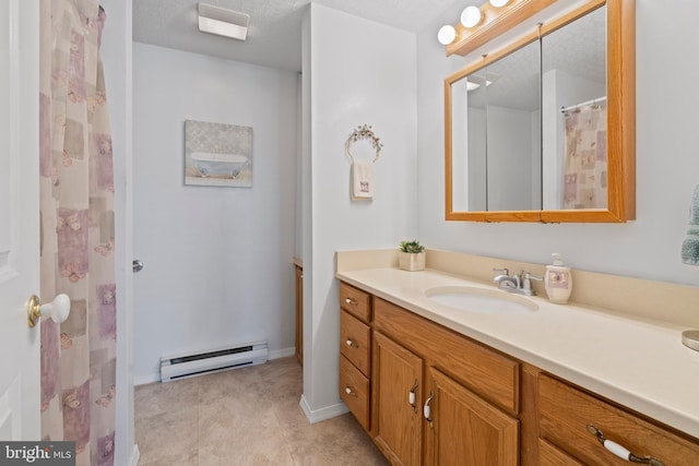 bathroom with a textured ceiling, vanity, and a baseboard radiator