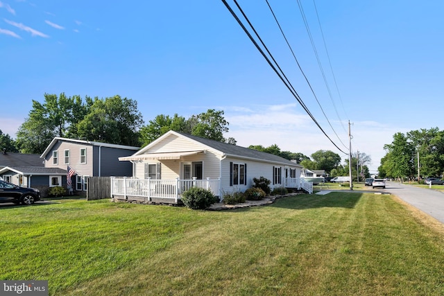 view of front of house with a front yard and covered porch