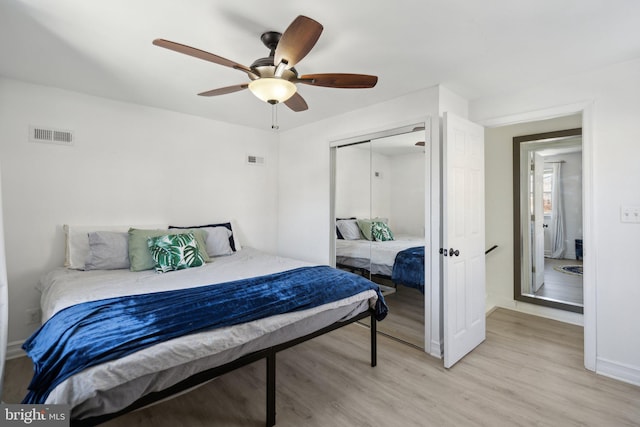 bedroom featuring ceiling fan, a closet, and light hardwood / wood-style floors