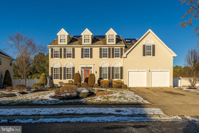 view of front of property with a garage and solar panels