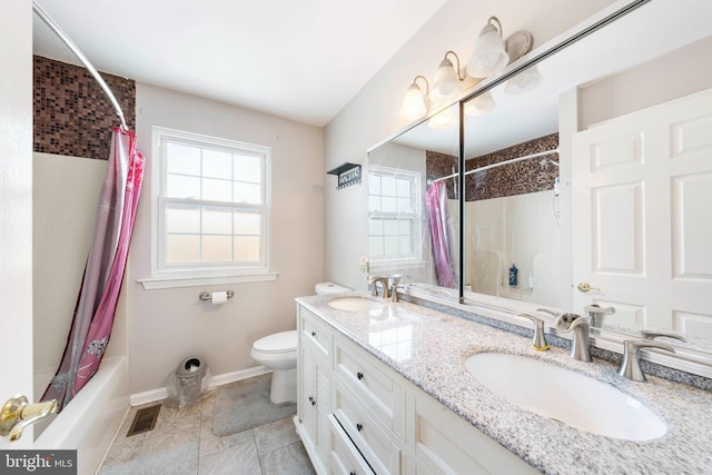 full bathroom with vanity, shower / bath combo, and toilet