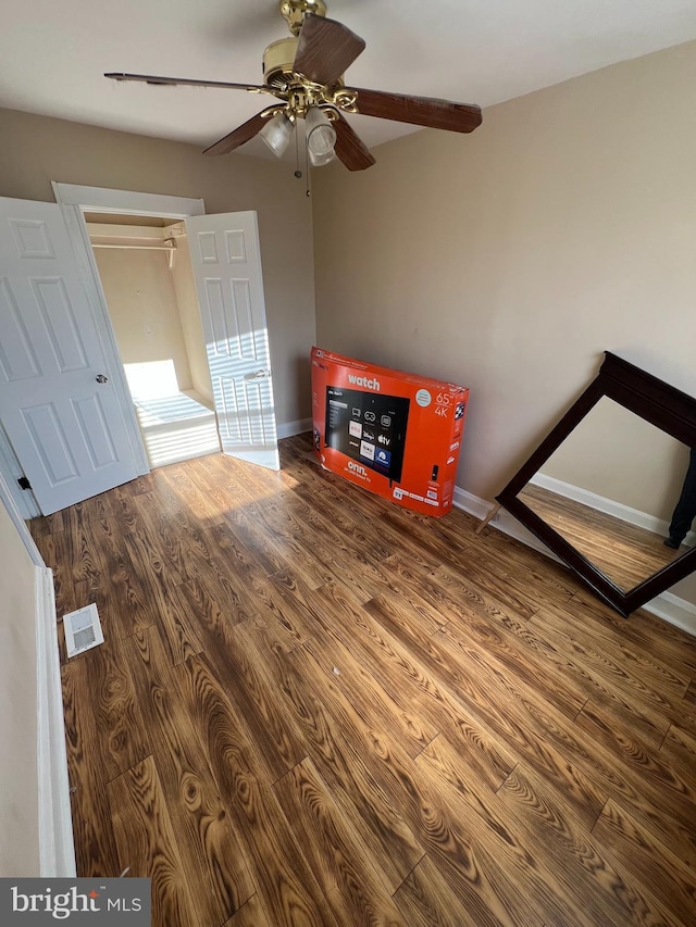 unfurnished bedroom with ceiling fan and wood-type flooring