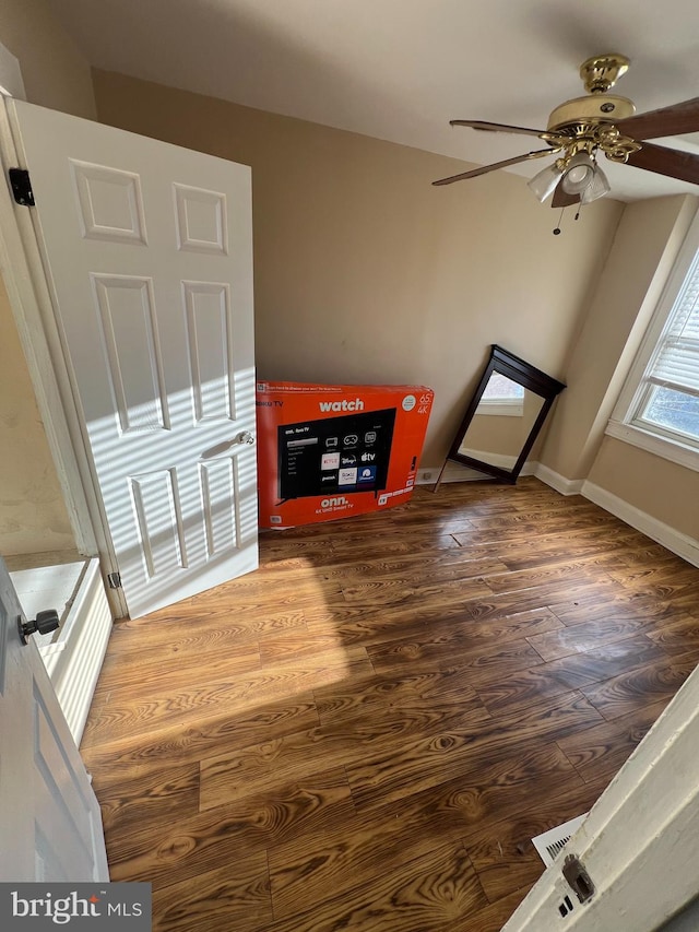 living room featuring ceiling fan and wood-type flooring