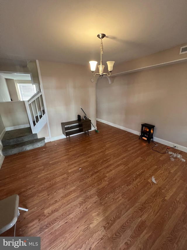 unfurnished dining area with hardwood / wood-style floors and a chandelier