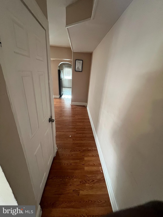 corridor with dark hardwood / wood-style flooring