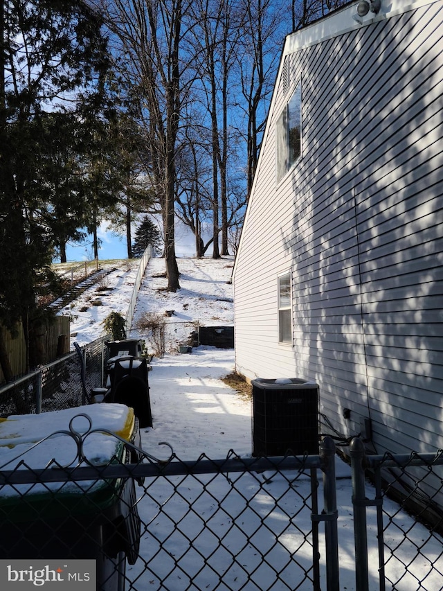 snow covered patio with central air condition unit