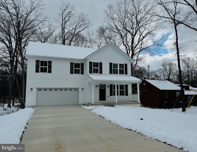 modern farmhouse with a porch, an attached garage, and driveway