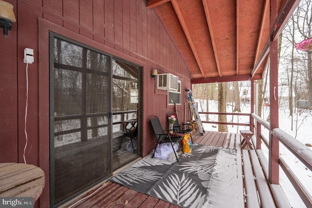 sunroom with a wall unit AC and lofted ceiling