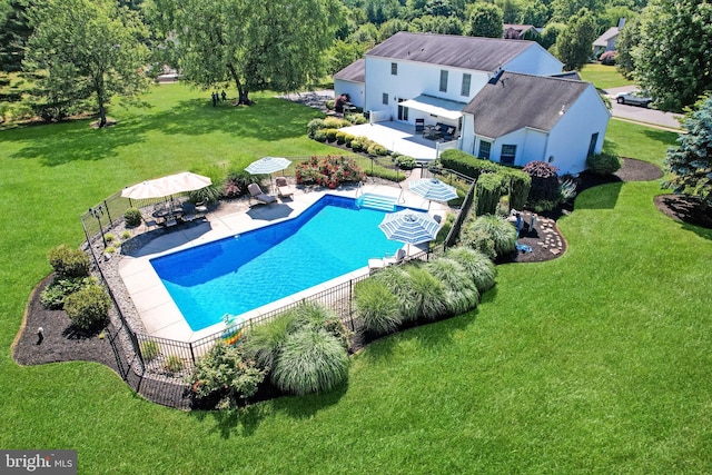 view of swimming pool featuring a lawn and a patio