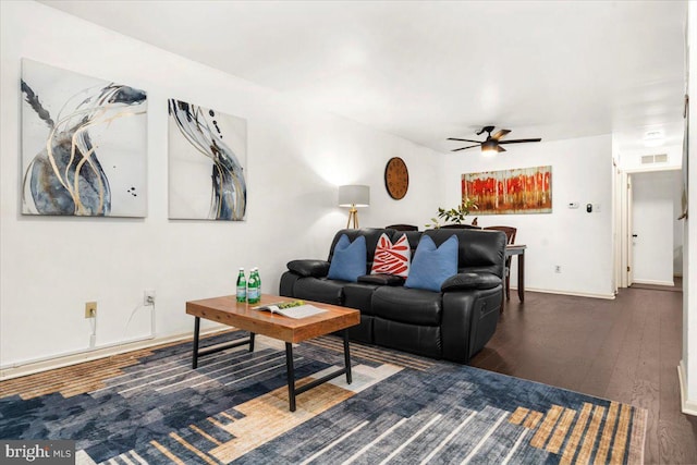 living room with dark hardwood / wood-style floors and ceiling fan