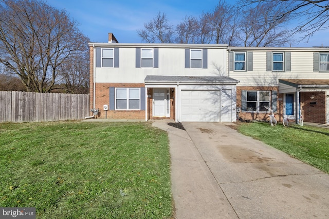 view of front of home with a front yard and a garage