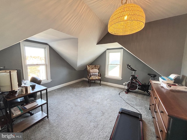 office area with dark colored carpet and vaulted ceiling