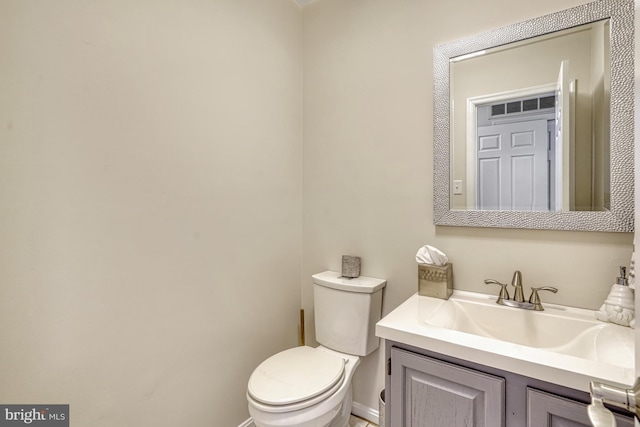 bathroom with toilet and vanity