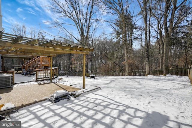 yard layered in snow featuring central air condition unit and a pergola