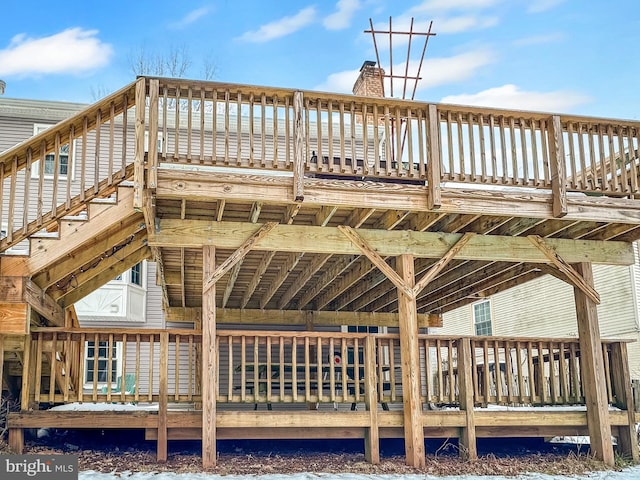 rear view of property featuring a wooden deck