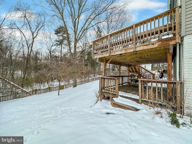 snowy yard with a wooden deck