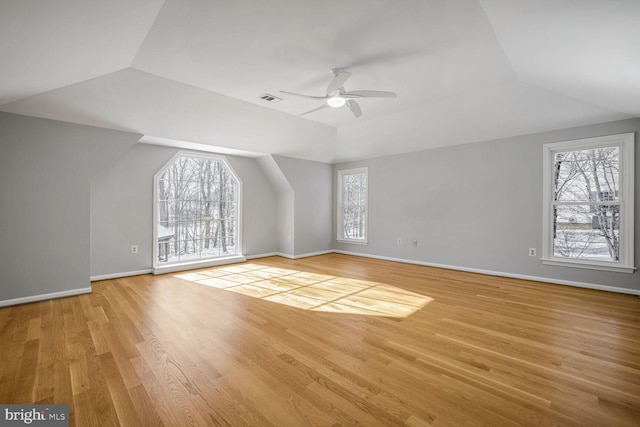 additional living space featuring ceiling fan, vaulted ceiling, and light hardwood / wood-style flooring