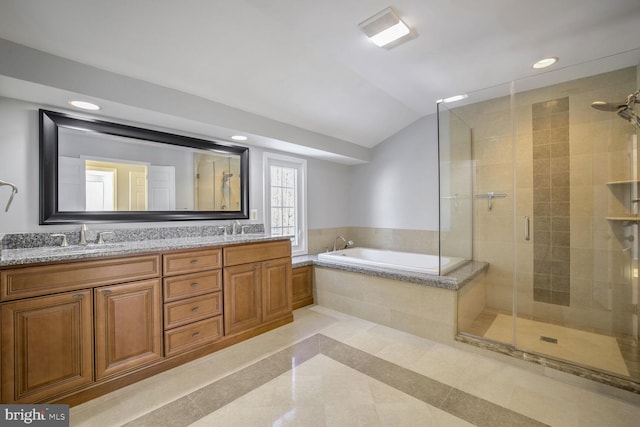 bathroom with separate shower and tub, tile patterned flooring, vaulted ceiling, and vanity