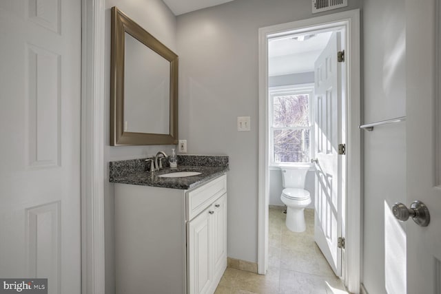 bathroom featuring toilet and vanity