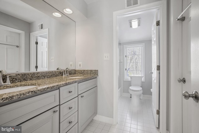 bathroom featuring tile patterned flooring, vanity, and toilet