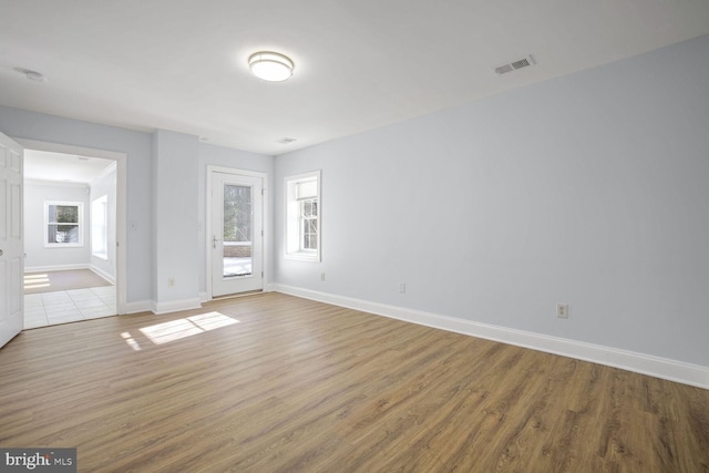 spare room with hardwood / wood-style floors