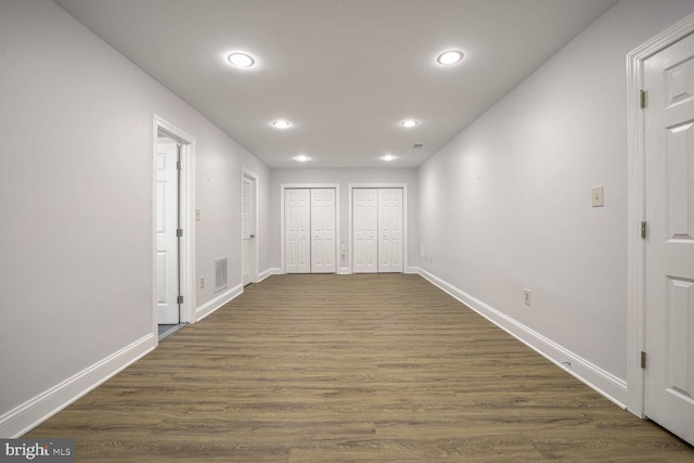 corridor with dark hardwood / wood-style flooring