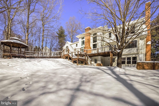 snow covered property with a gazebo