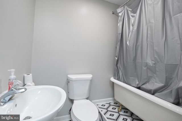 full bathroom with shower / bath combo, toilet, and sink