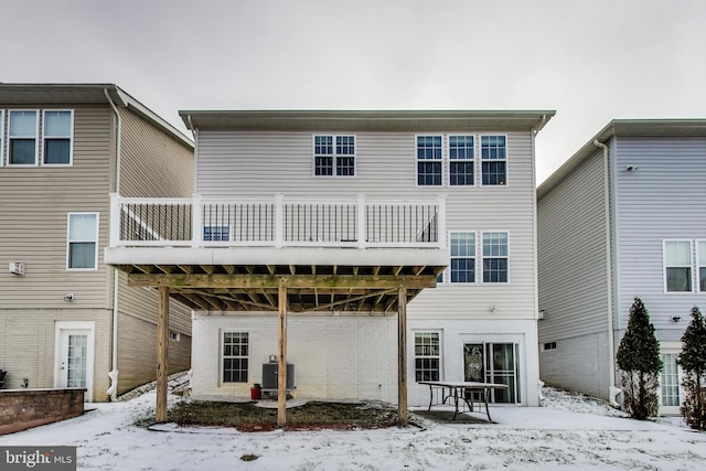 snow covered house with central air condition unit