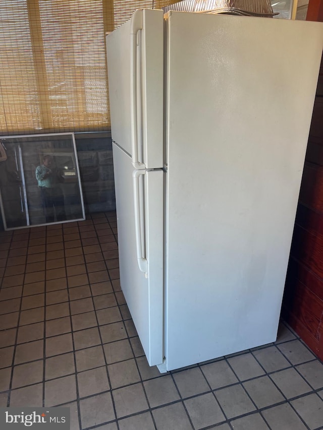 kitchen featuring light tile patterned floors and freestanding refrigerator