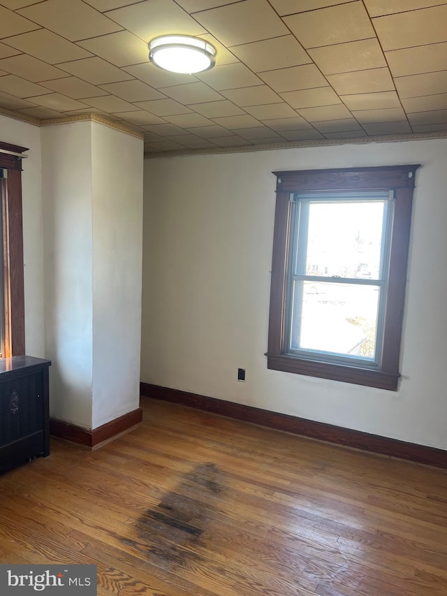 unfurnished room with wood finished floors and baseboards