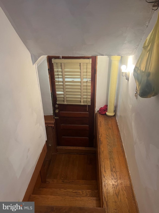 stairs with baseboards and wood finished floors