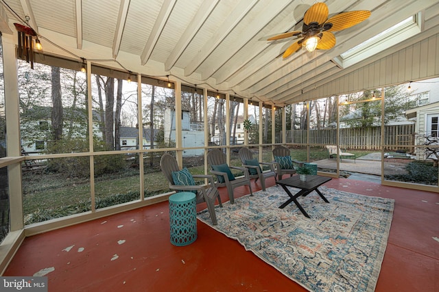 sunroom featuring ceiling fan and lofted ceiling with skylight