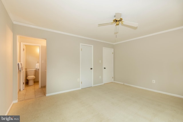 unfurnished bedroom with ornamental molding, ensuite bath, and light carpet