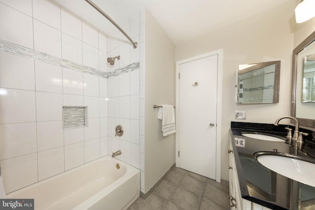 bathroom featuring vanity, tile patterned flooring, and tiled shower / bath combo