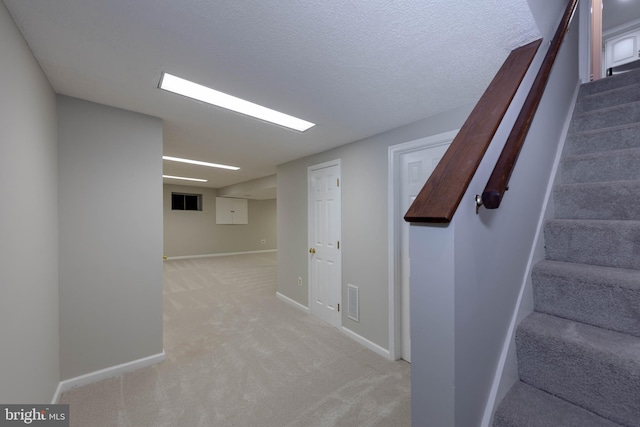 interior space featuring carpet and a textured ceiling