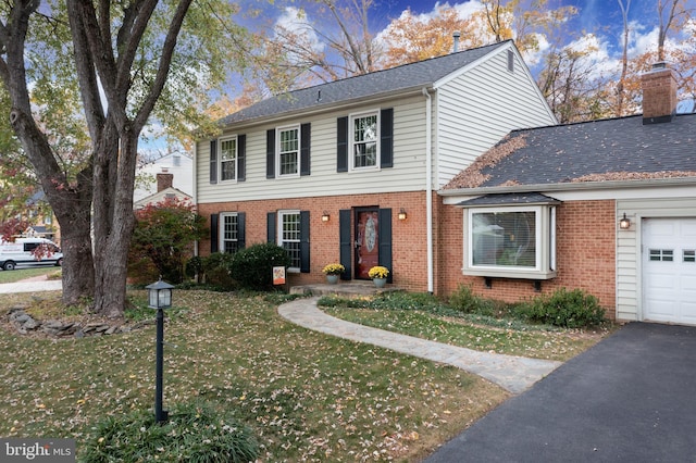 view of front of house with a garage and a front yard