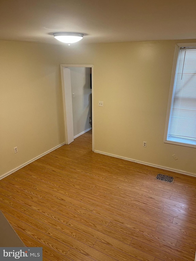 empty room featuring plenty of natural light and light wood-type flooring