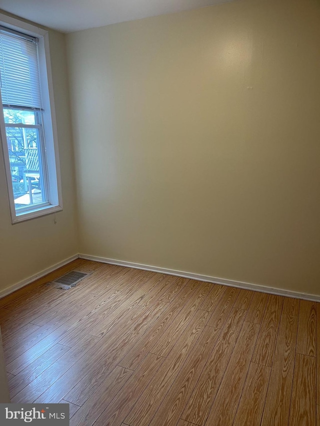 spare room with light hardwood / wood-style flooring