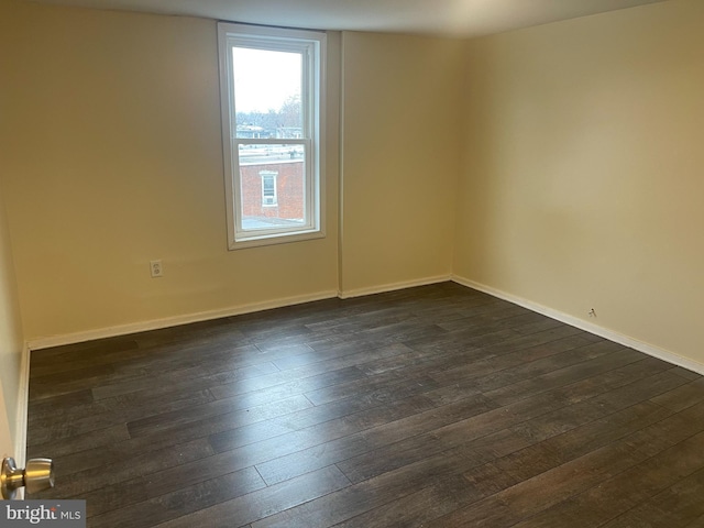 spare room featuring dark wood-type flooring